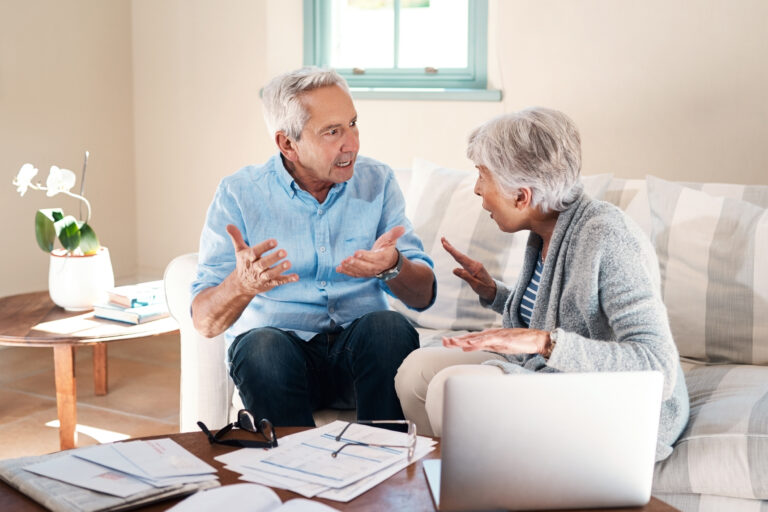 Frustrated, old couple and laptop for finance, argument and bills with gambling debt and expenses. Divorce, pc and documents with man, woman and home loan with inflation, bankruptcy and conflict.